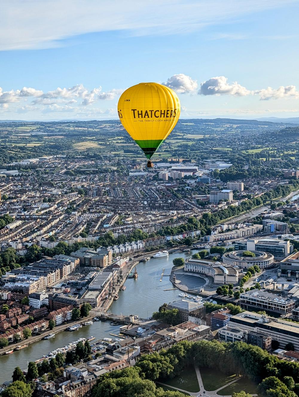 Hot air balloon flying over city of bristol