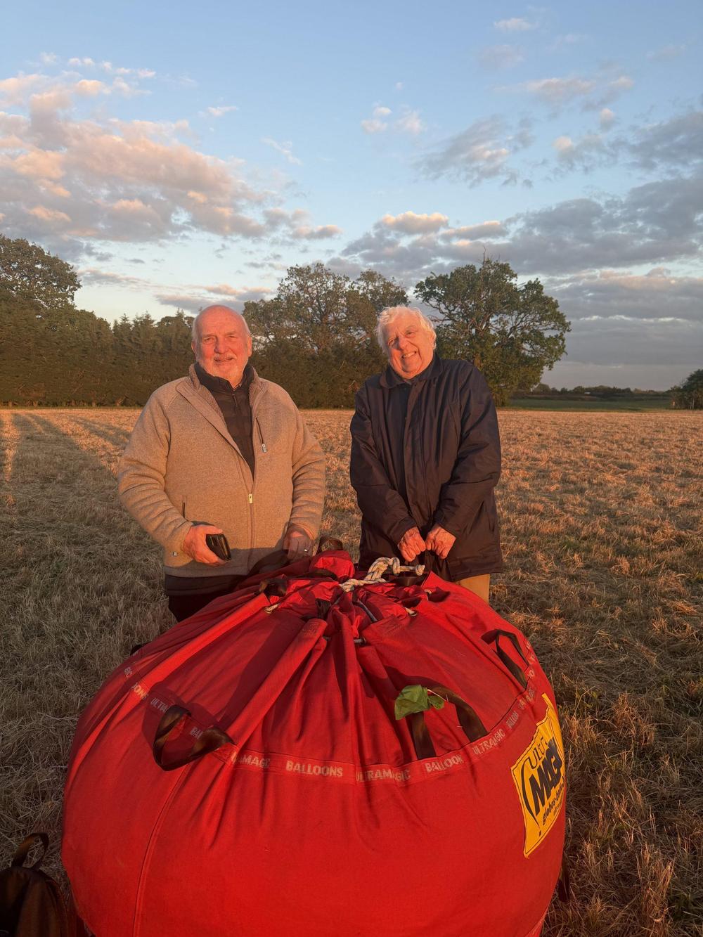 two men next to packed away balloon after private hot air balloon ride over east midlands
